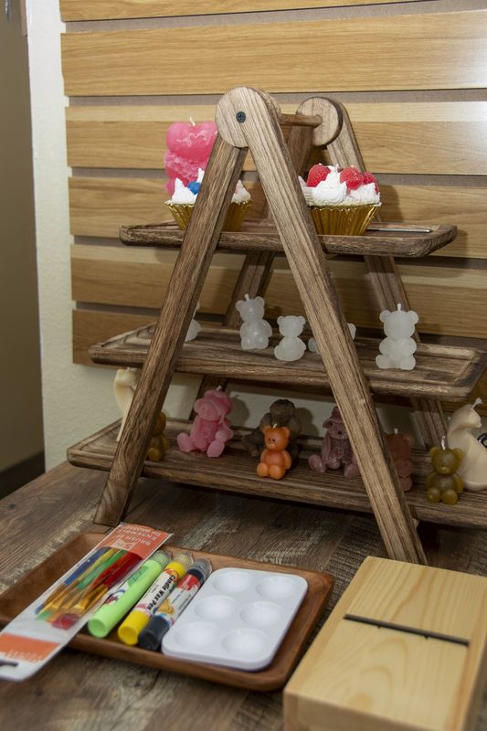 A wooden A-frame ladder of cupcake and animal candles