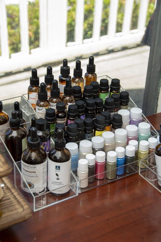 A tray of fragrance oils and pigment bottles