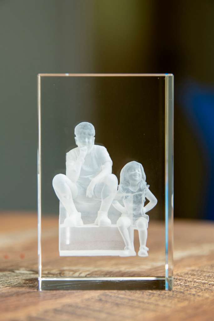 A laser-etched crystal keepsake of two children